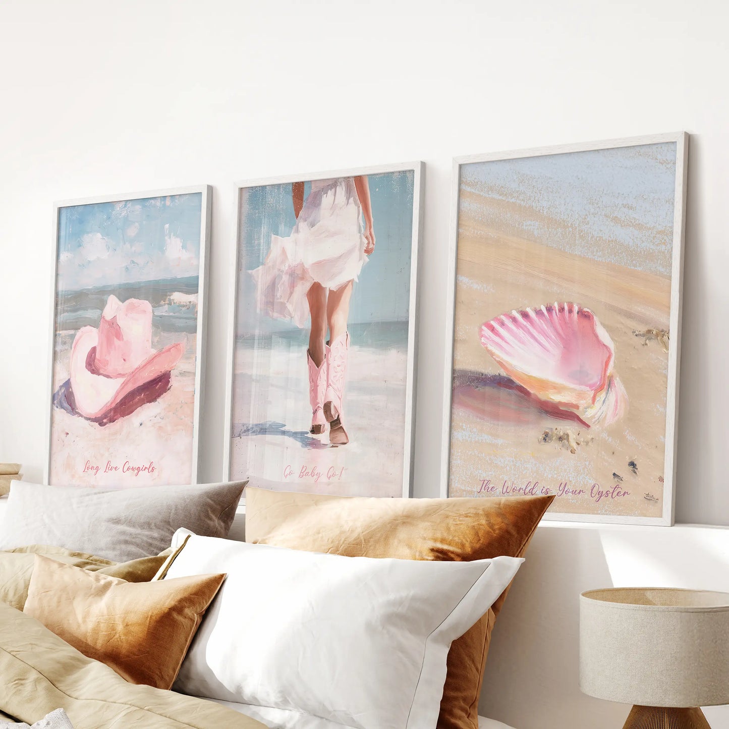 Pink seashells set of three framed wall art in white, placed above the bedroom bed to layer a gentle shoreline vibe with girly summer color.