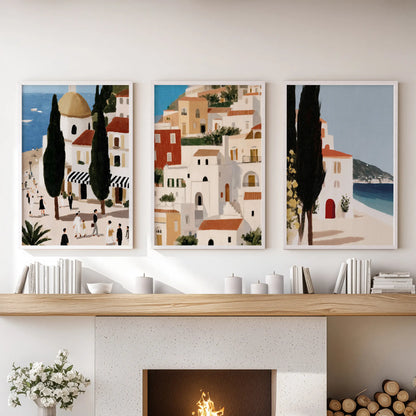 Mediterranean coast landscapes, three-piece wall art set in white-framed prints, sit in the lounge above the fireplace with breezy, sunlit balance.