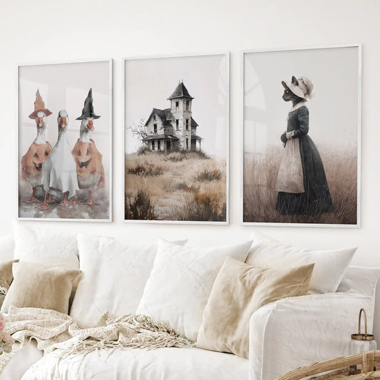 Cottagecore Halloween gallery wall set of 3 prints featuring witchy animals, a haunted house, and soft autumnal tones. White frames for living room.