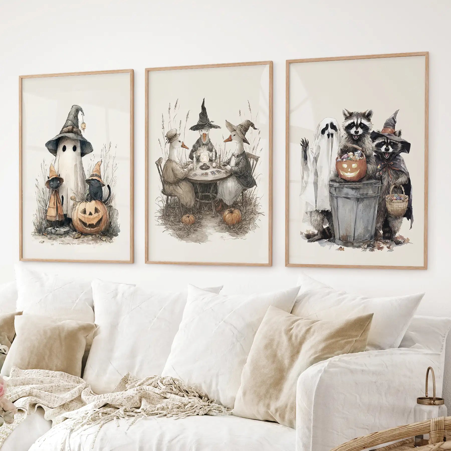 Seasonal Halloween artwork with playful raccoons, pumpkins, and ghost. Thinwood frames over the couch.