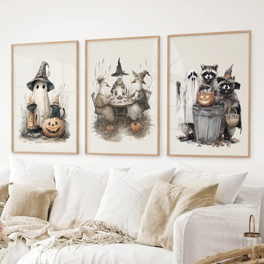 Seasonal Halloween artwork with playful raccoons, pumpkins, and ghost. Thinwood frames over the couch.
