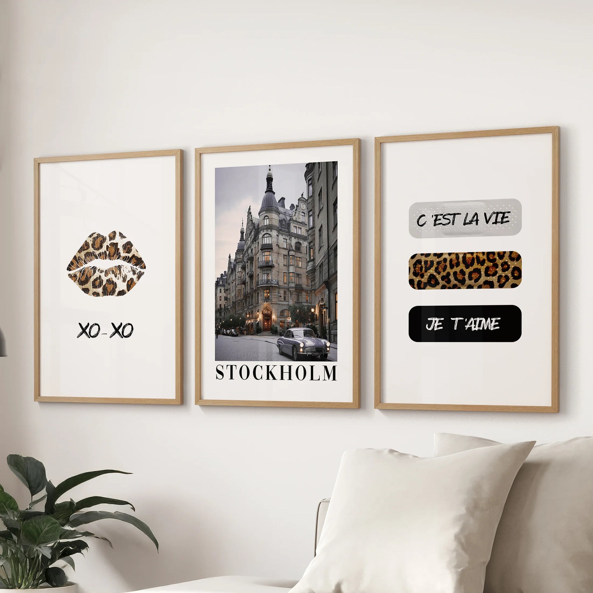 Large coquette-style collage art in a set of three light-wood-framed prints brightens the sitting room wall just above the couch.