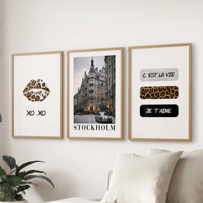 Large coquette-style collage art in a set of three light-wood-framed prints brightens the sitting room wall just above the couch.