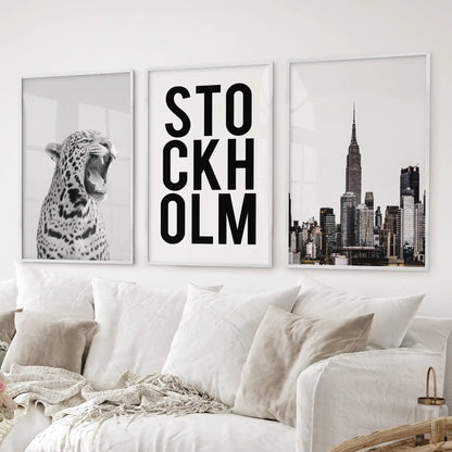 Set of 3 wall posters featuring leopard art, Stockholm text design, and New York architecture in black and white minimalist style. White frames for living room.