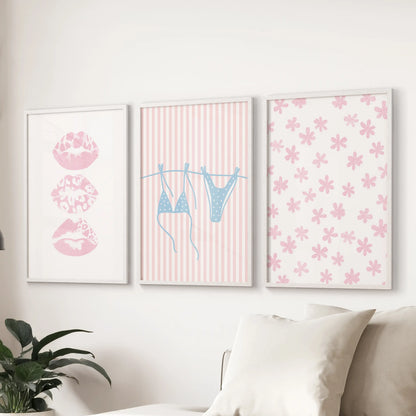 Summer shoreline posters, a set of three, stretch above the sectional in the living room, cleanly finished in white frames.