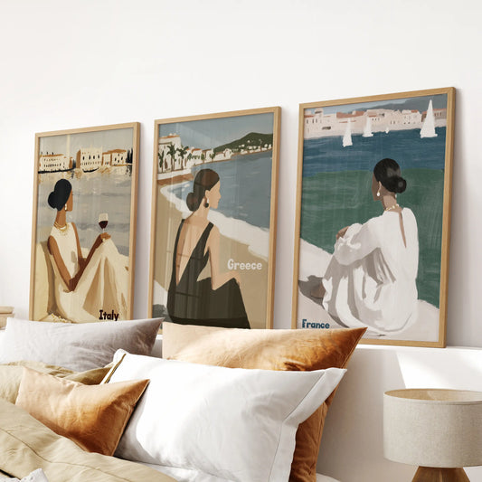 A light-oak framed art set of three hangs over the bed, infusing the bedroom with the warmth of sunlit stucco and sailing-day calm.