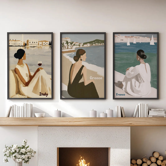 Above the hearth in the sitting room, a three-piece European seaside wall set in slim black frames recalls sun-warmed stone and surf.