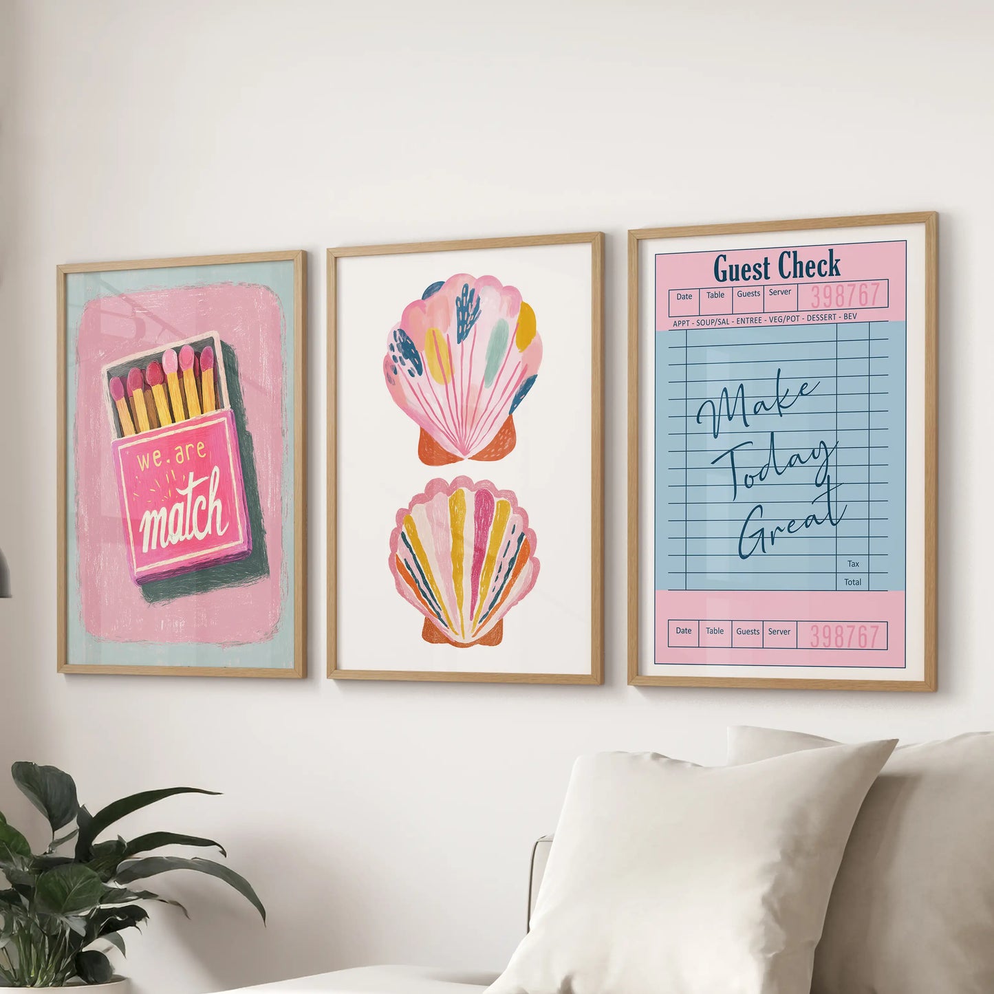 Three light-wood-framed wall pieces with uplifting typography stretch behind the sitting-room couch for a fresh, summery look.