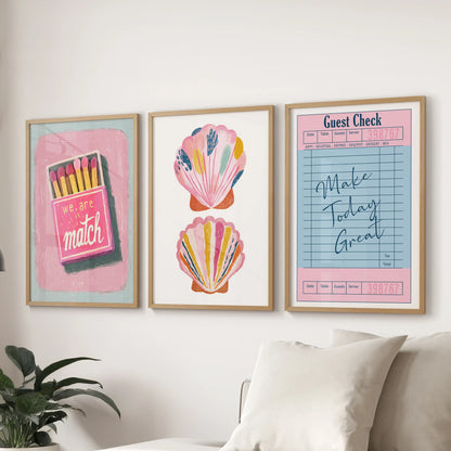 Three light-wood-framed wall pieces with uplifting typography stretch behind the sitting-room couch for a fresh, summery look.