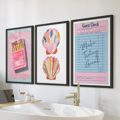 Print set of three coastal beachy wall art for the bathroom in black frames, arranged over the tub for a bright, preppy splash.