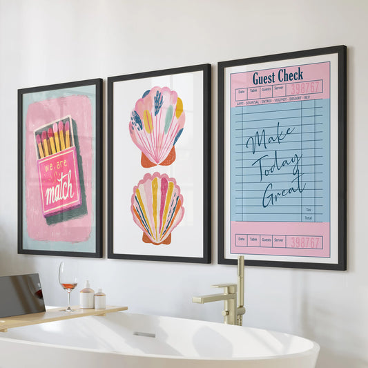 Print set of three coastal beachy wall art for the bathroom in black frames, arranged over the tub for a bright, preppy splash.