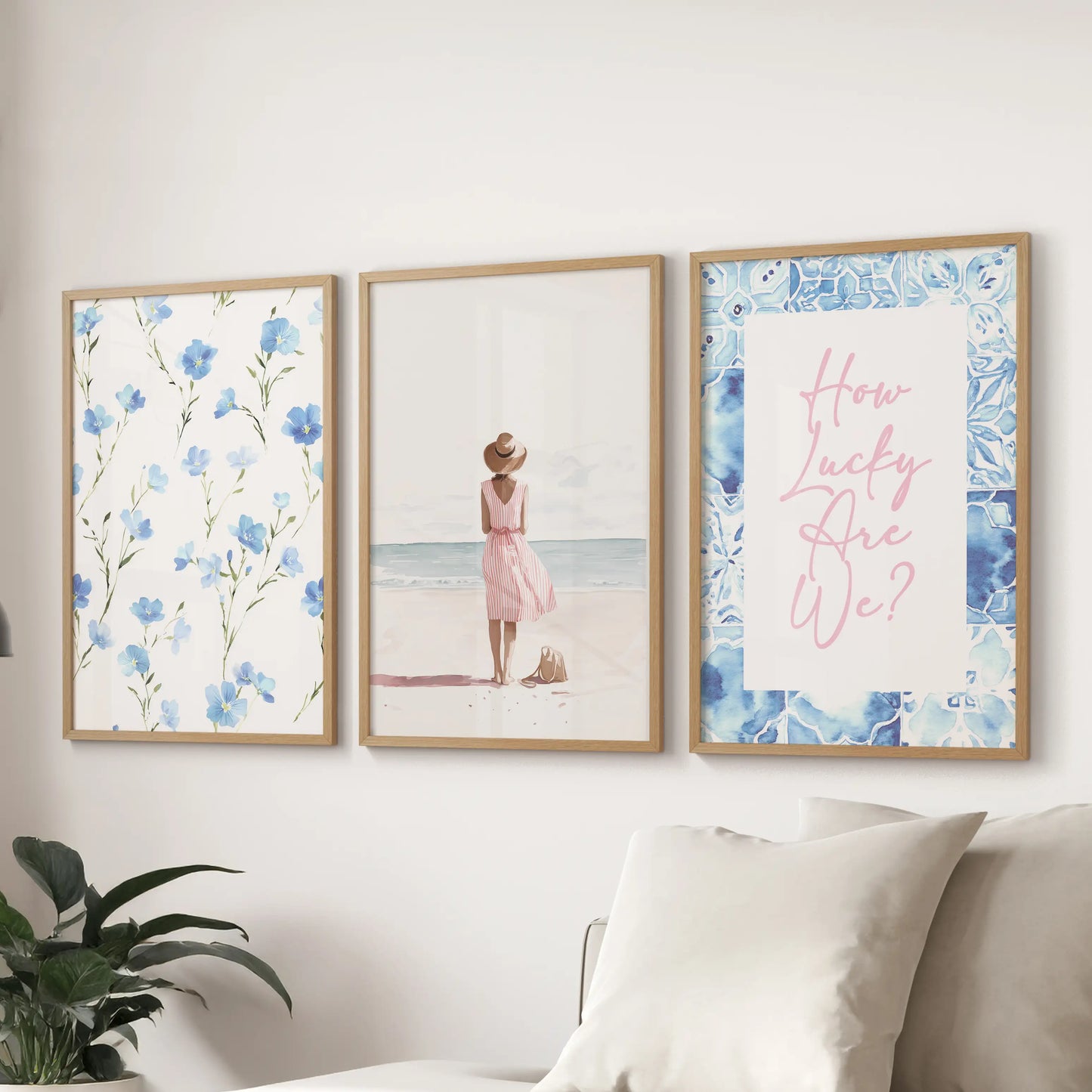Wood-framed three-piece wall art with a granddaughter theme is displayed above the couch, blending soft blues and gentle coastal warmth in the sitting room.