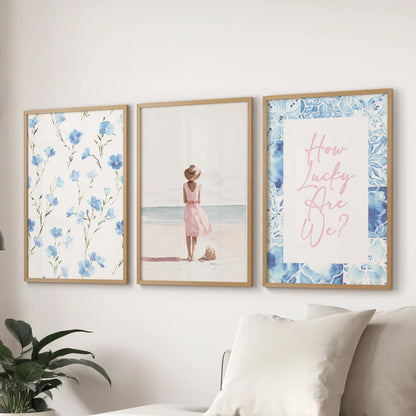 Wood-framed three-piece wall art with a granddaughter theme is displayed above the couch, blending soft blues and gentle coastal warmth in the sitting room.
