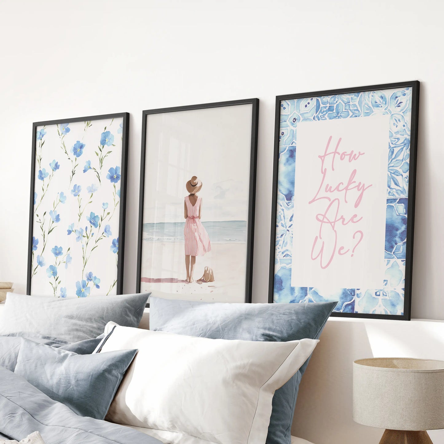 This black-framed three-print wall art set of beach girls illustrations hangs above the headboard, lending breezy, summer energy to the blue bedroom.