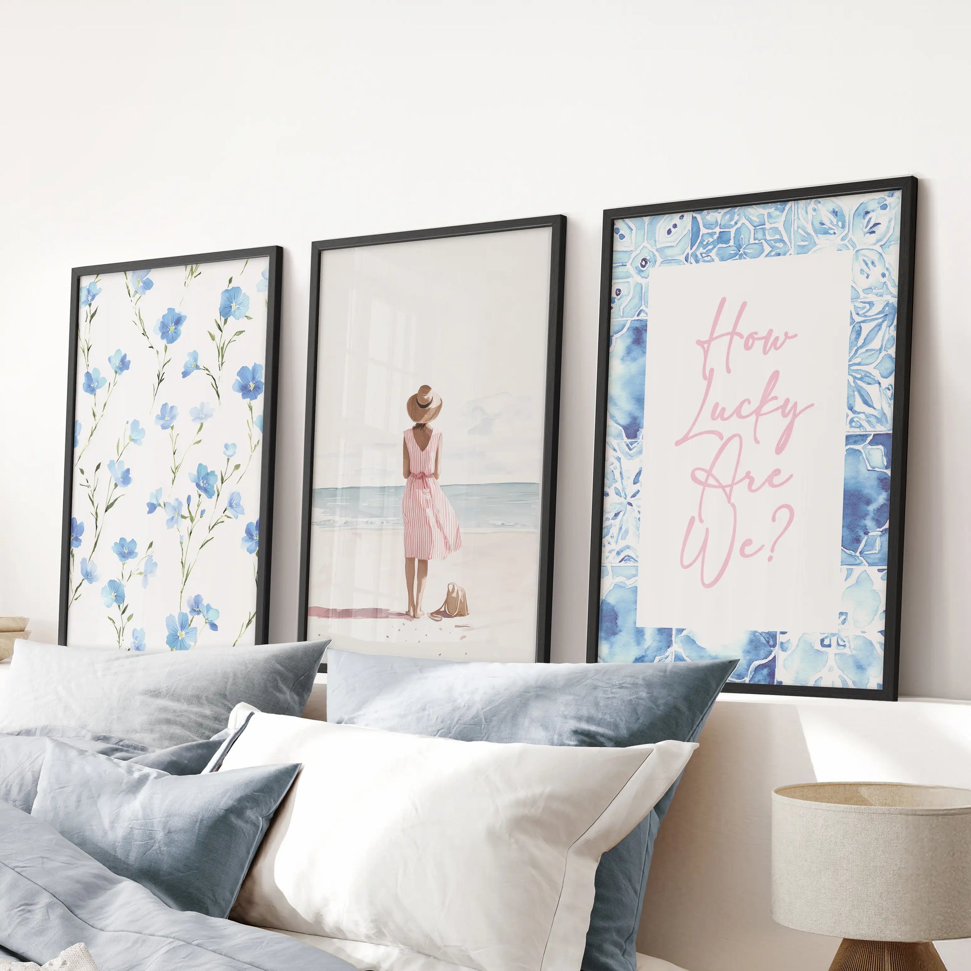 This black-framed three-print wall art set of beach girls illustrations hangs above the headboard, lending breezy, summer energy to the blue bedroom.