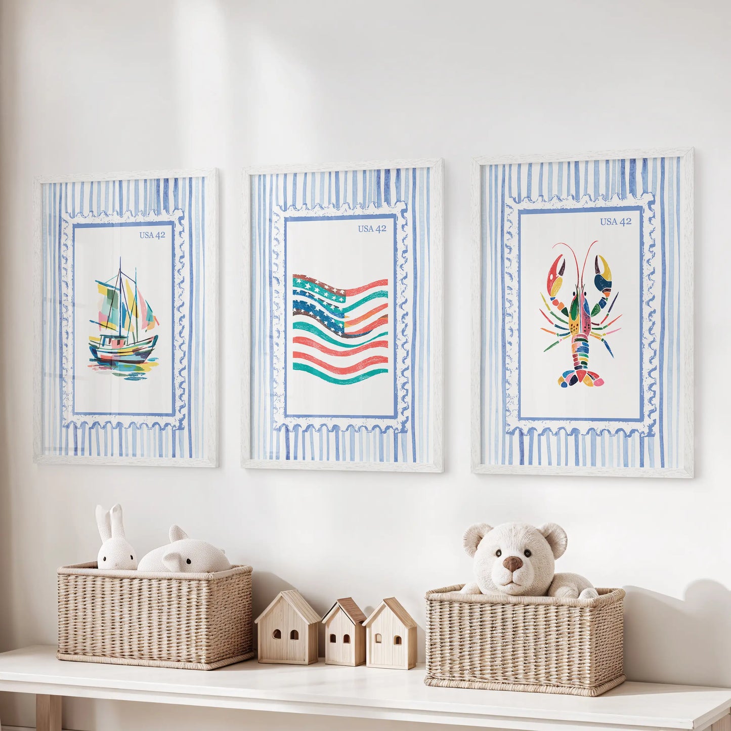 Three white-framed beach stamp art prints hang above the toy bench, adding bright seaside color to the kids’ room.