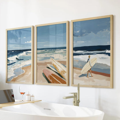 Coastal surf seascapes wall art, a three-piece set in light wood frames, hangs above the bathtub to warm the bathroom with sunlit, watery blues.
