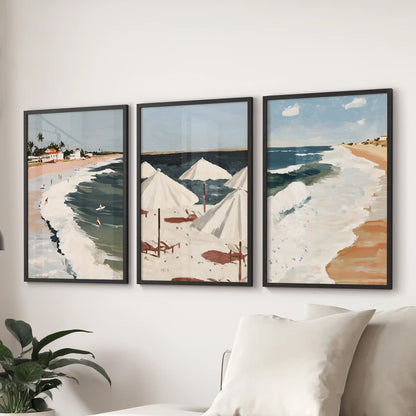 This trio of surf-coast prints in black frames anchors a breezy wall display above the sitting room couch with flowing shoreline energy.