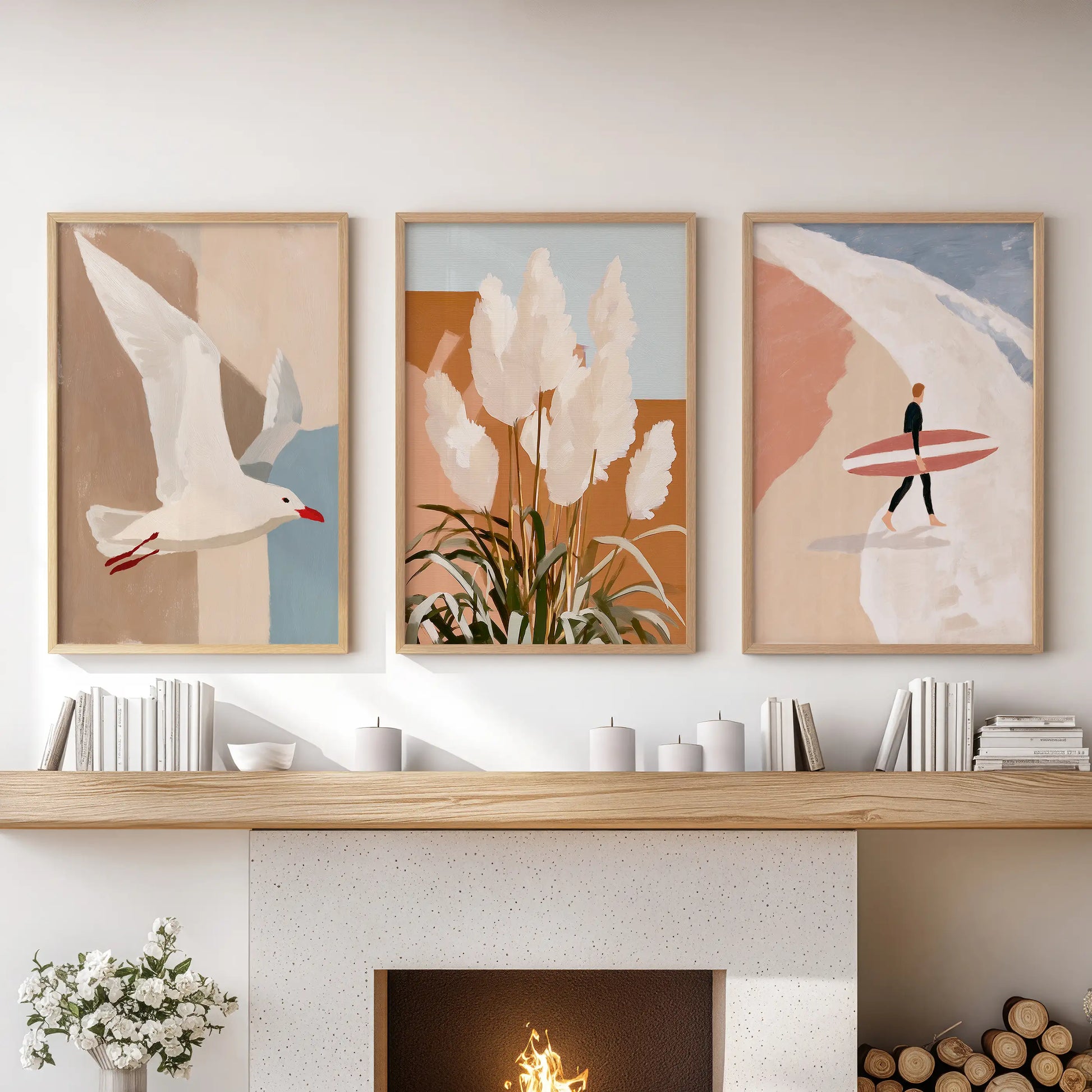 A trio of thin wood-framed surfer prints sits above the fireplace mantel, bringing a clean, modern coastal touch to the living room.