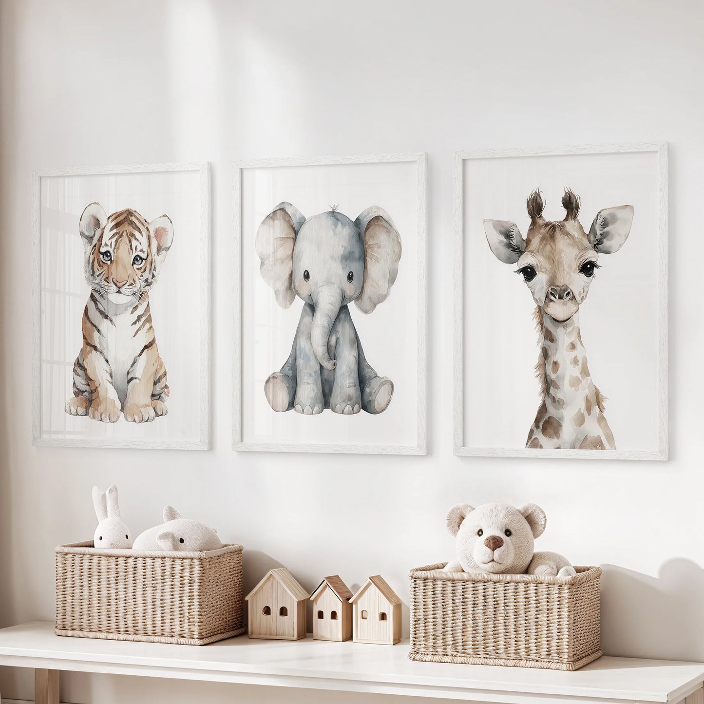 Watercolor tiger cub, elephant calf and giraffe prints arranged as a gallery above toys.