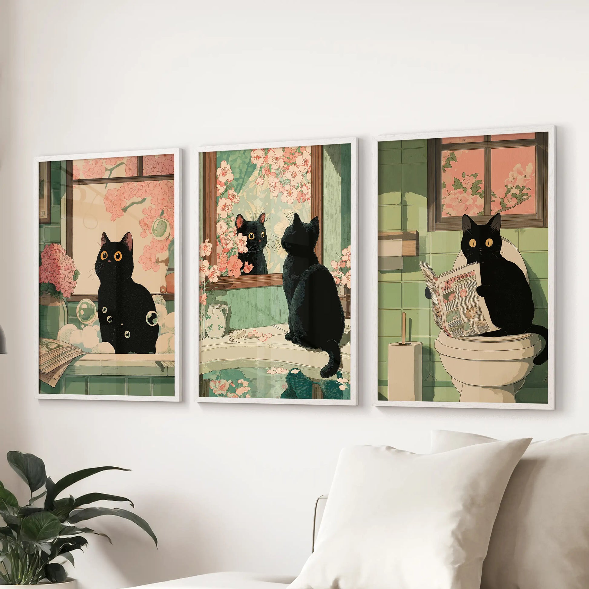 Cheeky black cat bathroom scene, set of three white-framed wall prints, enlivens the lounge and sits smartly over the sofa.