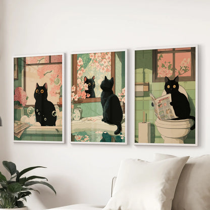 Cheeky black cat bathroom scene, set of three white-framed wall prints, enlivens the lounge and sits smartly over the sofa.