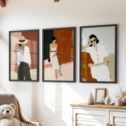 A 3-piece wall art set of modern women fashion illustrations in black frames sits over the dresser, giving the room  a polished feel.