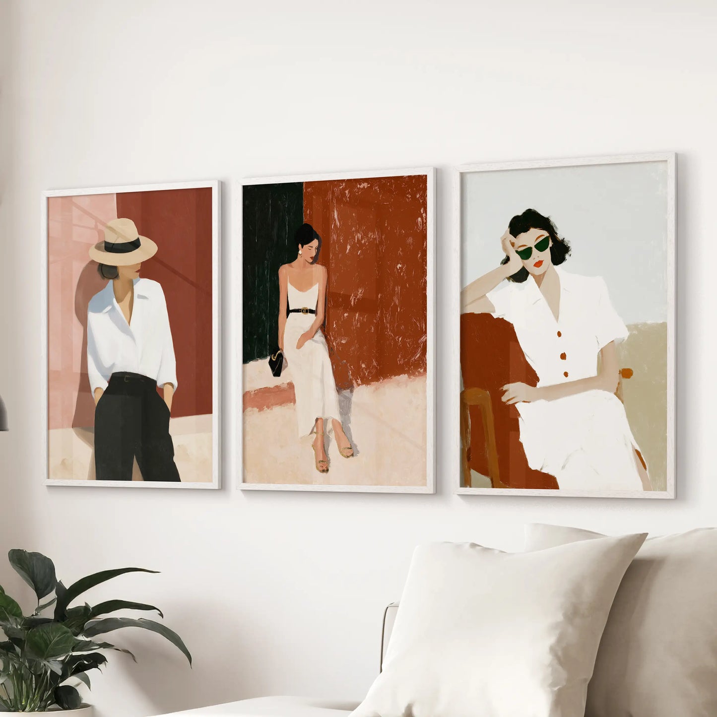 Relaxed summer travel scenes with women, a set of 3 wall art prints in slim white frames, settle over the couch to bring airy escape to the lounge.
