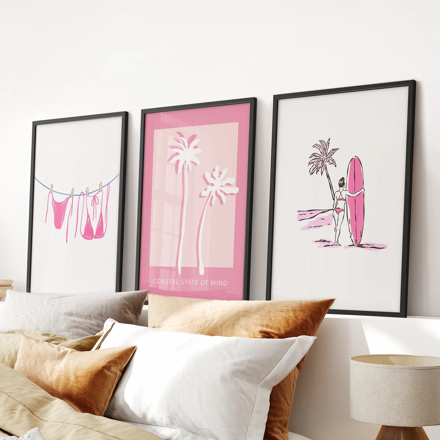 Palm tree poster 3-piece poster set in a black frame hangs above the bed headboard, bringing breezy beach wall art to a soft, stylish bedroom.