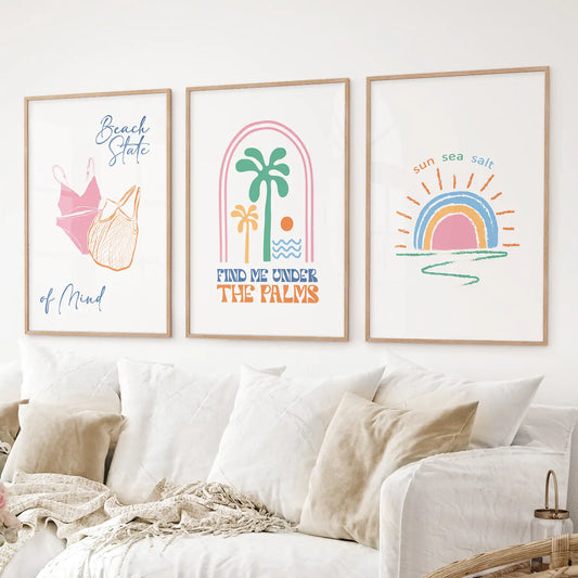 Tropical beach wall art set with palm tree, sun, and beach quotes in pastel colors. Thinwood frames over the couch.