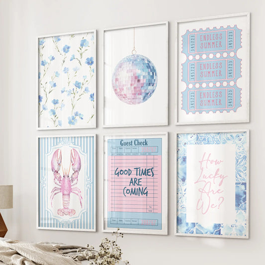 A set of six white-framed quote posters, blending blue and pink, hangs neatly beside the bed for a crisp, preppy dorm-like touch of color.