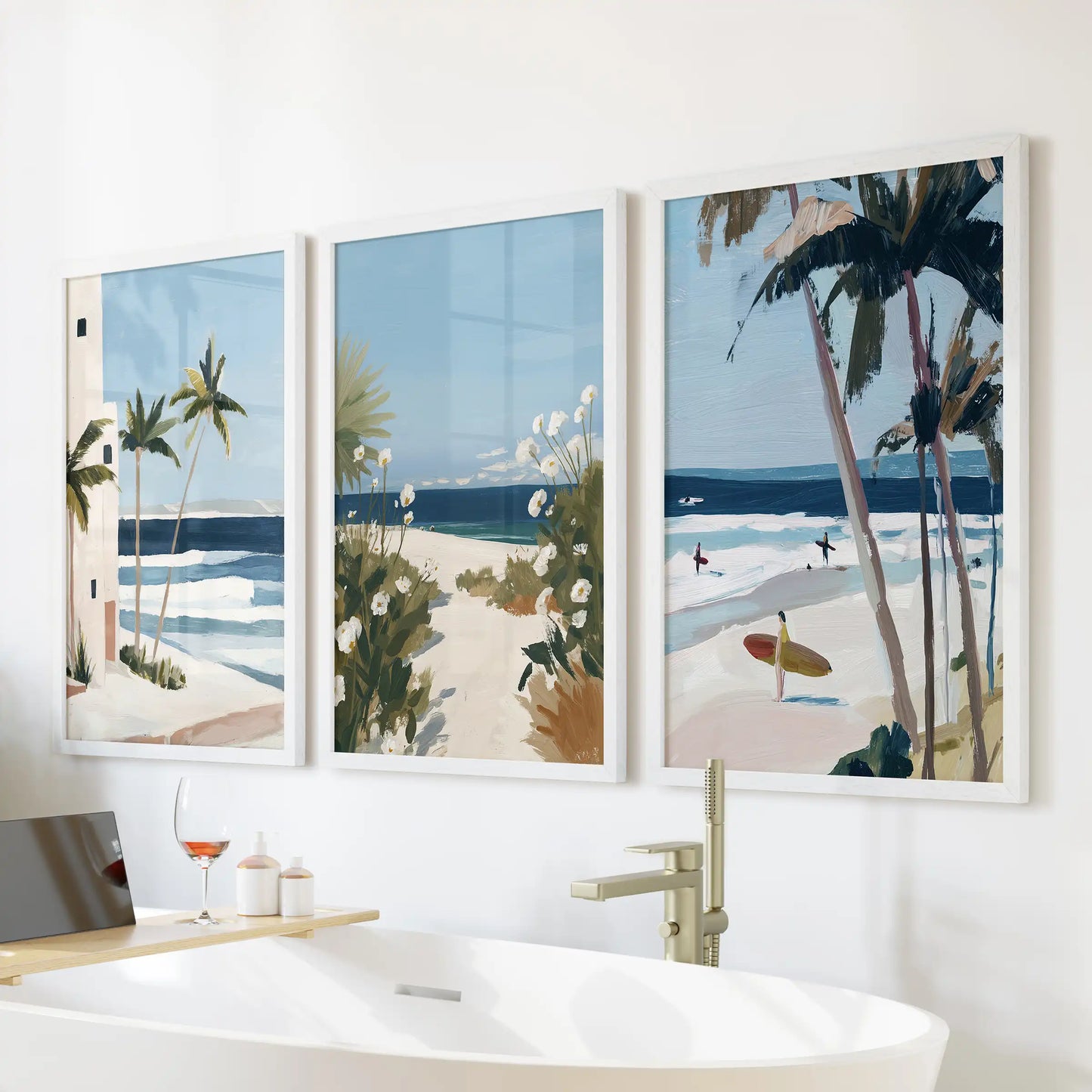 Set of three white-framed palm tree prints brightens the wall above the bathroom tub, adding a clean, coastal air to the space.