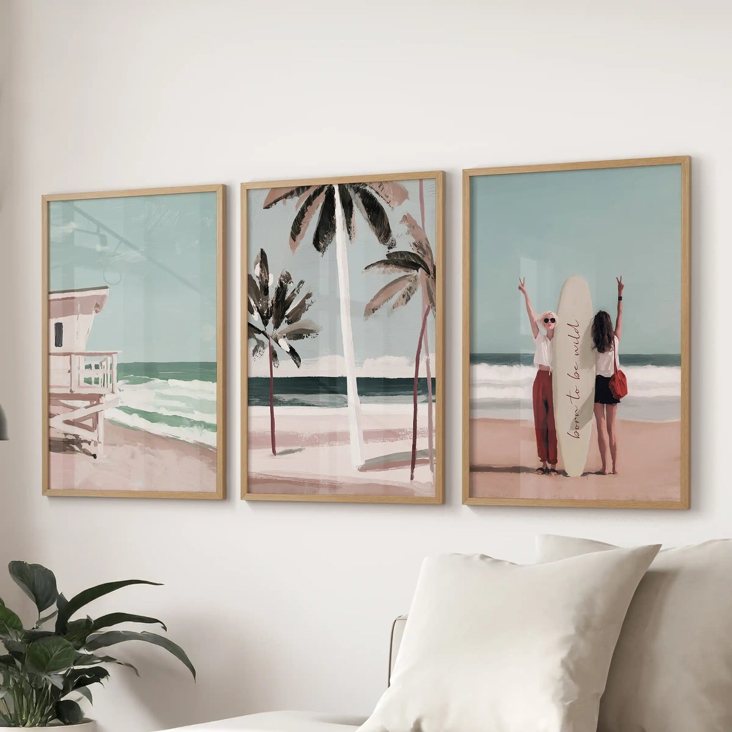 A set of three beach art prints in light-wood frames hangs over the sectional sofa, capturing relaxed Hamptons boardwalk charm in the lounge.