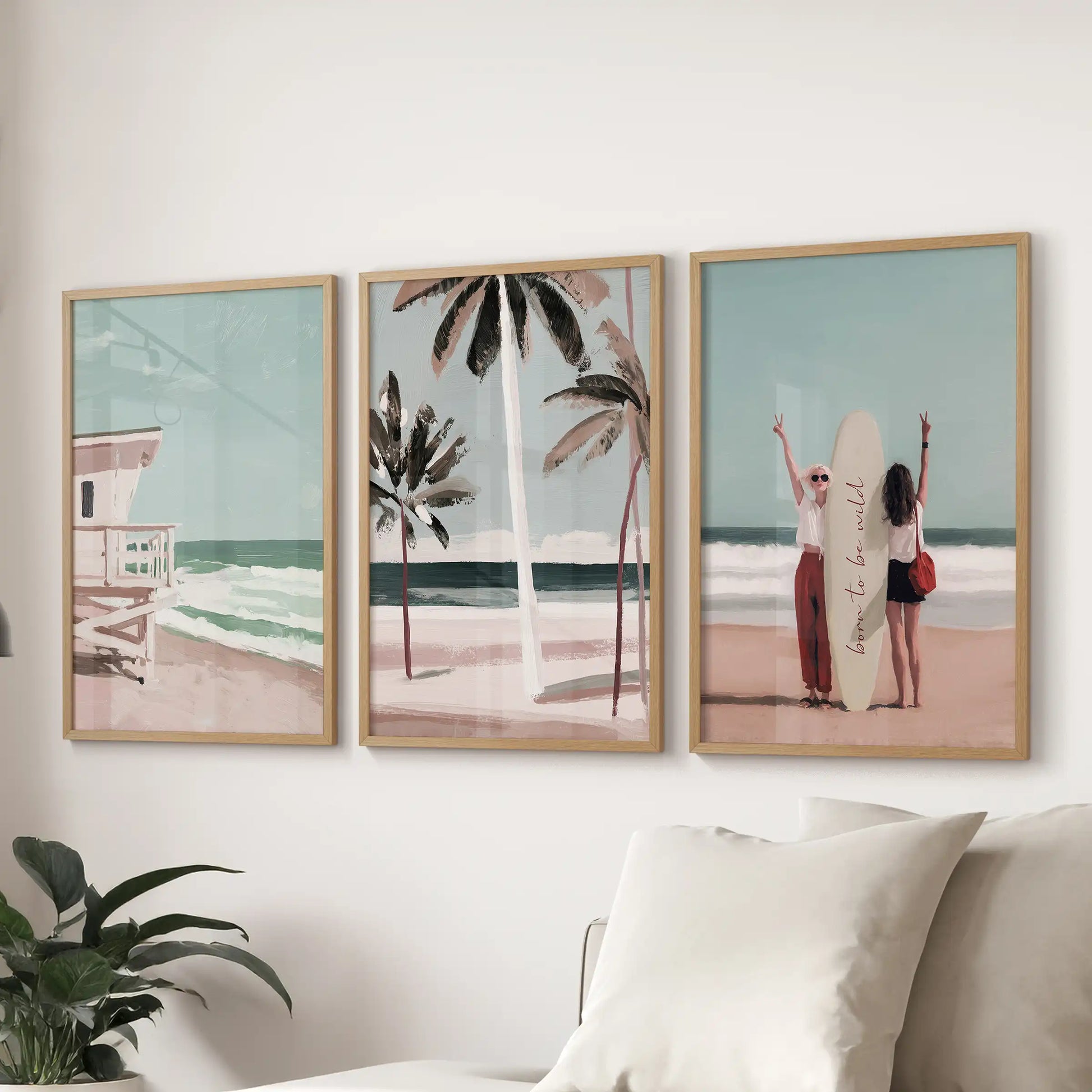 A set of three beach art prints in light-wood frames hangs over the sectional sofa, capturing relaxed Hamptons boardwalk charm in the lounge.