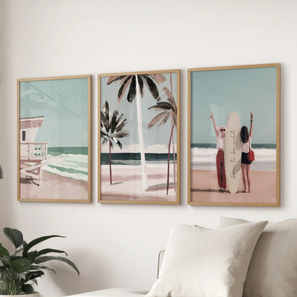 A set of three beach art prints in light-wood frames hangs over the sectional sofa, capturing relaxed Hamptons boardwalk charm in the lounge.