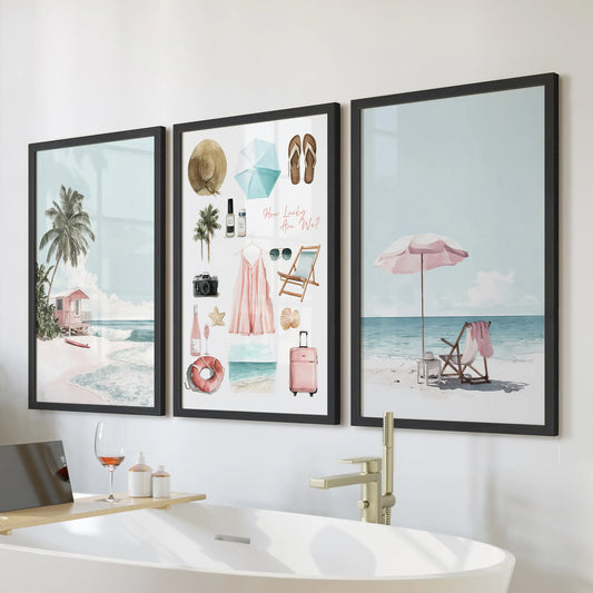 A three-piece wall art set with tropical beach scenes in black frames brings airy color above the freestanding tub in the bathroom.