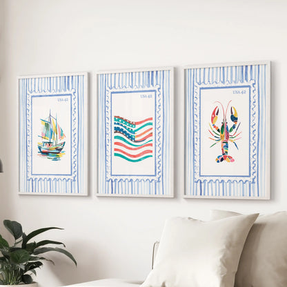 Lobster boat and US flag, a 3-print wall set in white frames, centered over the sofa to give the sitting room a crisp maritime accent.