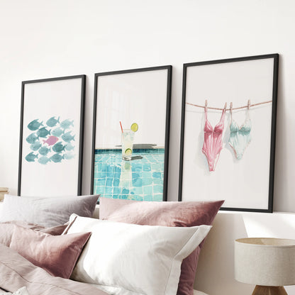 School of fish art prints set of three in black frames, arranged over the pink bedroom headboard to bring bold color and a breezy, preppy mood.