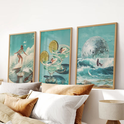 Vintage beach print set of three lends nostalgic wall art to a bedroom, mounted above the headboard in warm wooden frames with sun-washed blues.