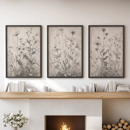 Minimal floral sketches in a set of three black-framed wall prints elevate the living room décor above the mantel.