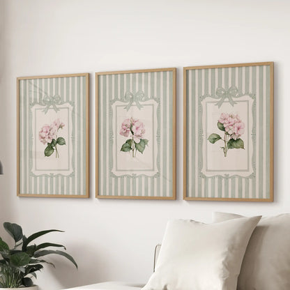Three-piece wall decor set of vintage botanical florals in light wood frames above a lounge sofa.