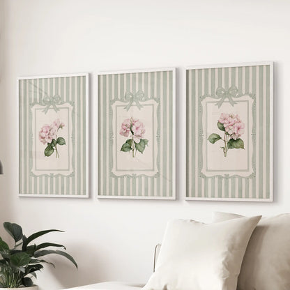 Set of three watercolor flower artworks in white frames above a family room sofa.