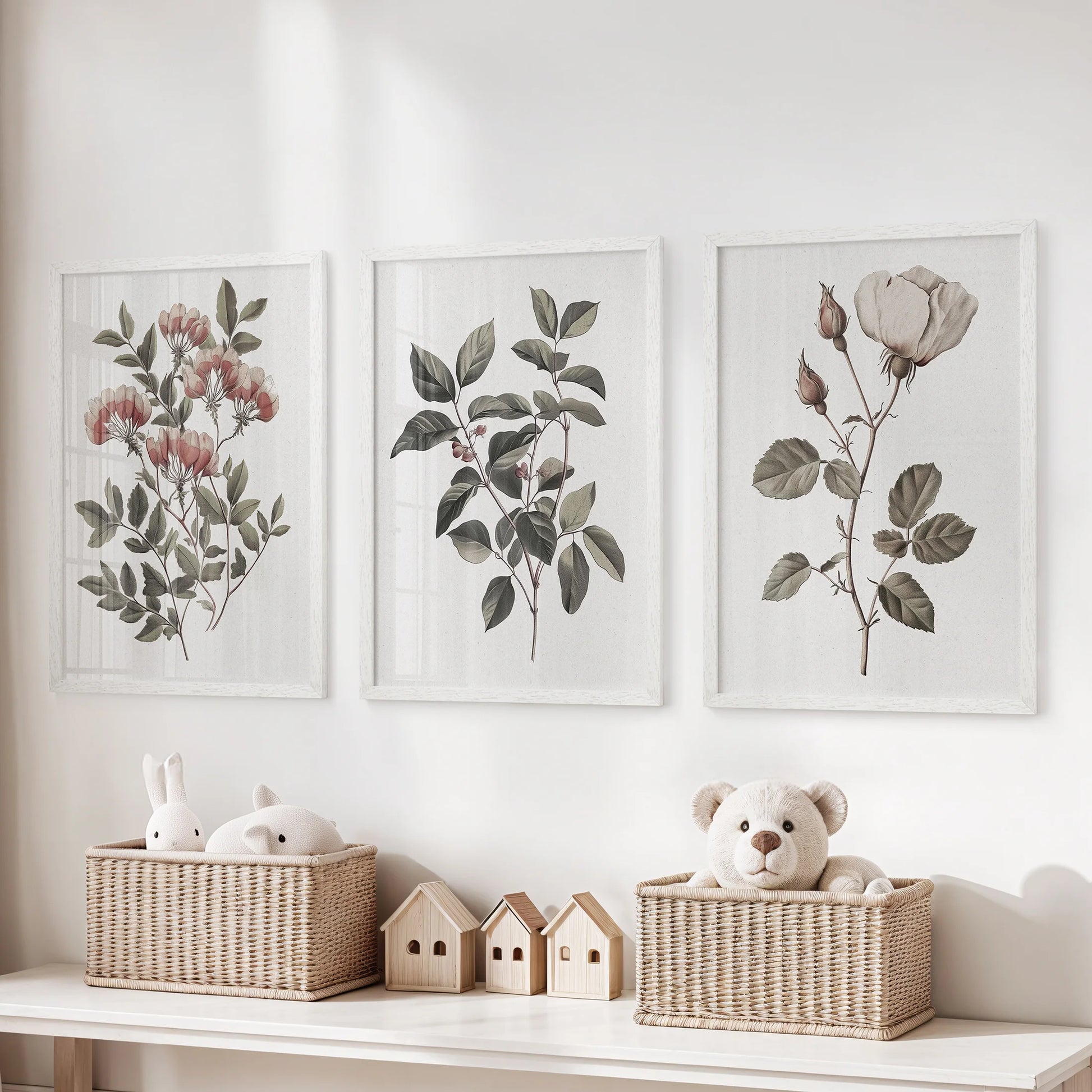 Neutral botanical triptych, a set of three wall hangings, rests above the toy organizer in the children's room, finished in crisp white frames for airy calm.