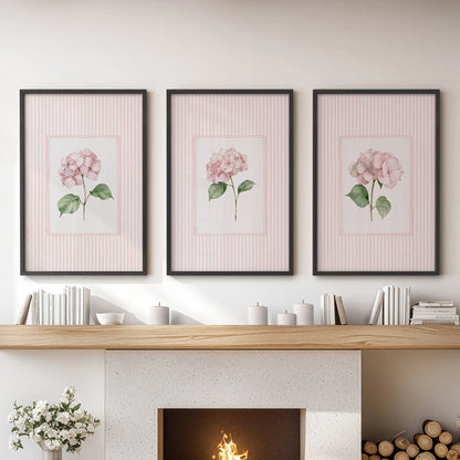 Vintage cottage florals in a three-picture wall art set hang over the mantel in a family room, each displayed in a black frame.