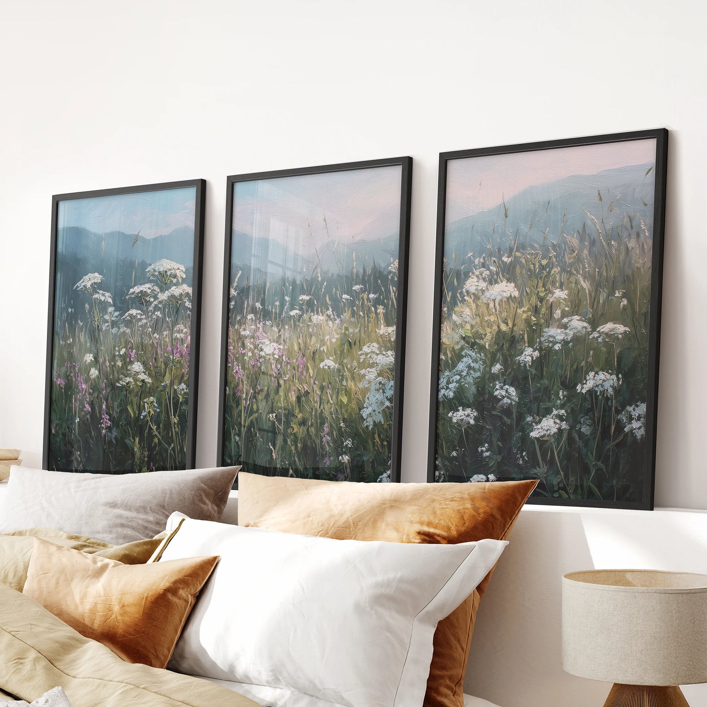 Floral meadow landscape three-piece wall art in black frames hangs over the bed, bringing soft neutral countryside tones to the bedroom.