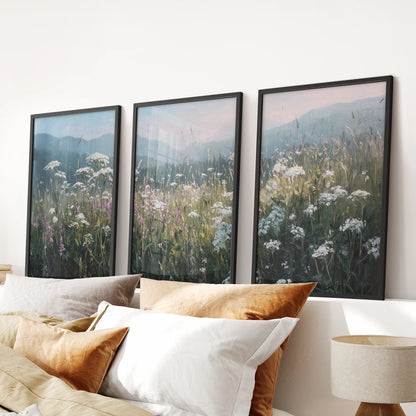 Floral meadow landscape three-piece wall art in black frames hangs over the bed, bringing soft neutral countryside tones to the bedroom.