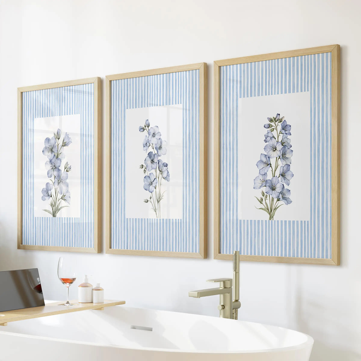 Vintage floral illustrations set of 3 wall prints in wood frames, displayed over a soaking tub in a bathroom.