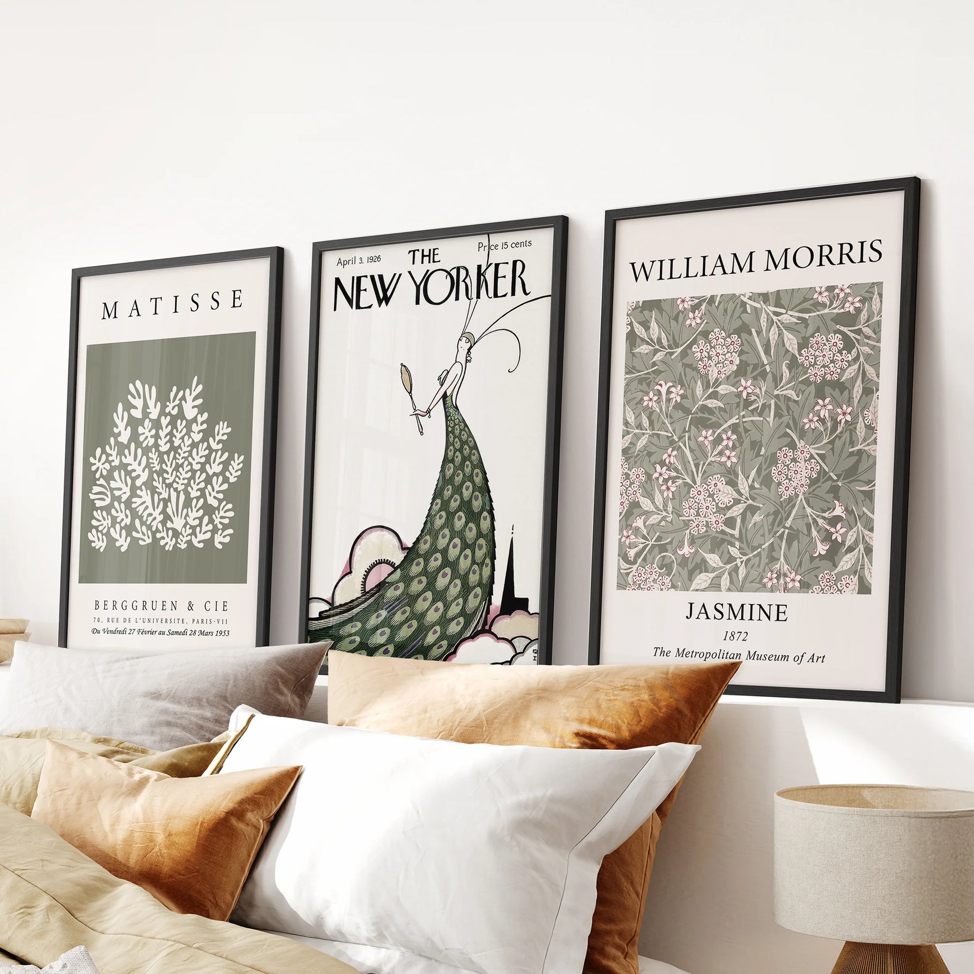 A trio of vintage New Yorker cover wall art in sleek black frames brings a nostalgic touch above the bedroom headboard.