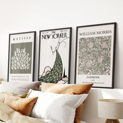 A trio of vintage New Yorker cover wall art in sleek black frames brings a nostalgic touch above the bedroom headboard.