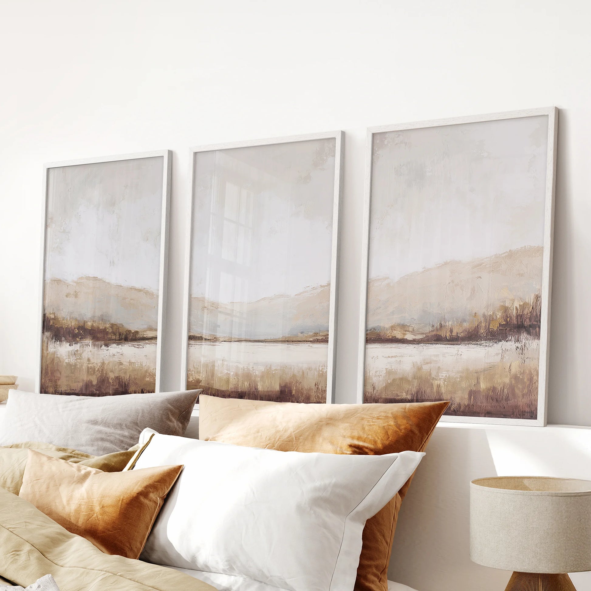 Minimalist nature landscape painting set of three in white frames centers the space above the headboard, keeping the bedroom airy and serene.